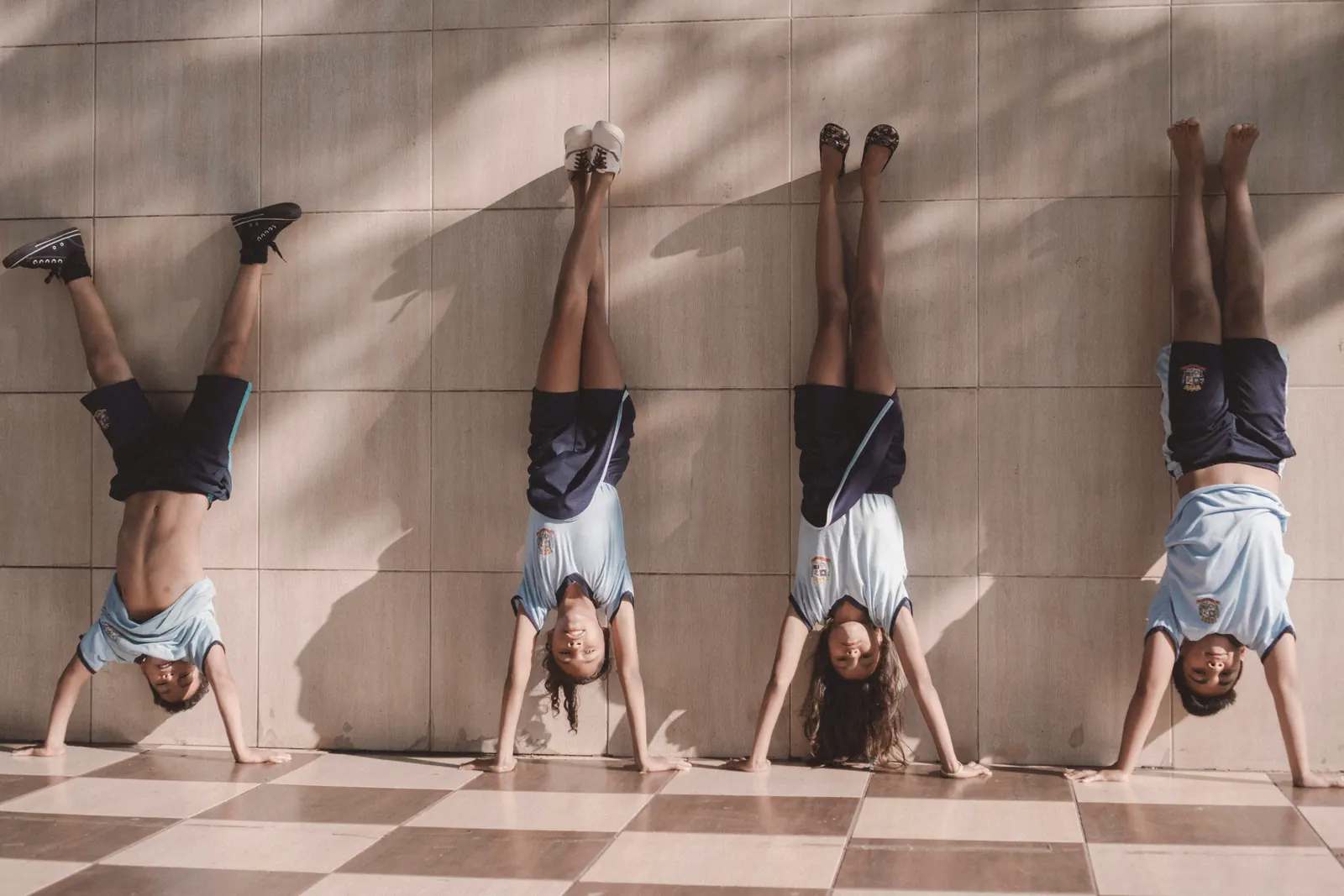 Children doing handstands together at a gymnastics birthday party
