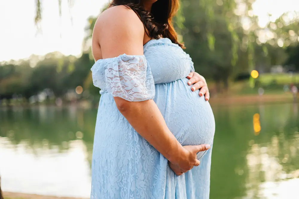 A pregnant woman swimming calmly in a warm indoor pool